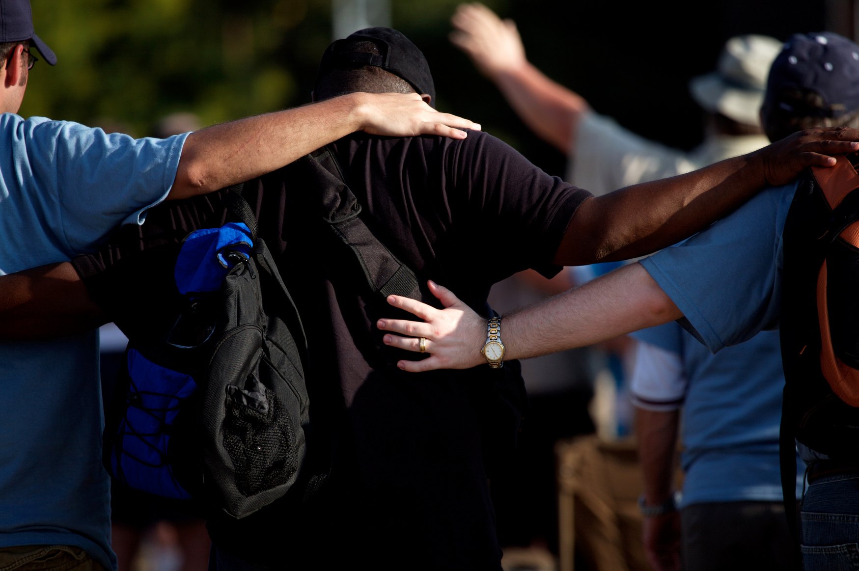 men gathering prayer embrace